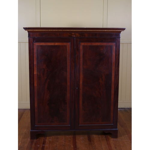 12 - A 19TH CENTURY MAHOGANY AND SATINWOOD INLAID CUPBOARD the moulded cornice above a pair of panel door... 