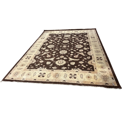 162 - A WOOL RUG the beige and brown ground with central panel filled with stylised flowerheads and foliag... 