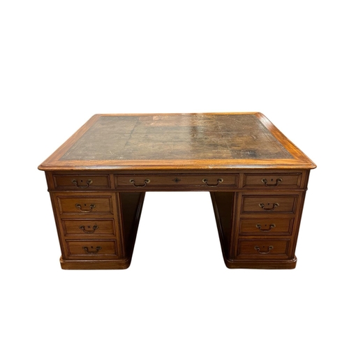 175 - A GEORGIAN STYLE MAHOGANY PARTNERS DESK of rectangular outline with tooled leather inset above three... 