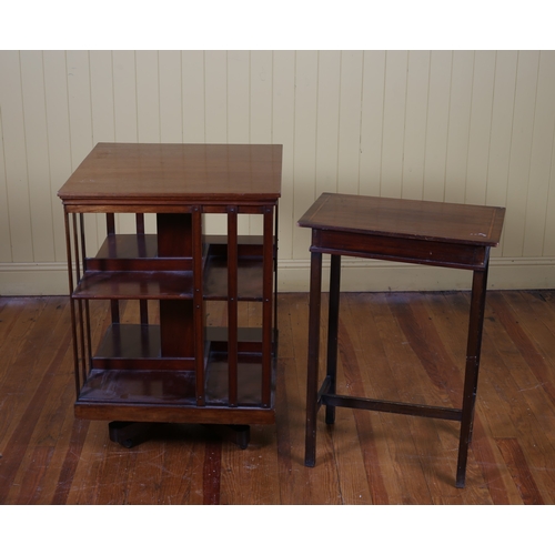 176 - A VINTAGE MAHOGANY REVOLVING BOOKSTAND the square moulded top above open compartments joined by slat... 