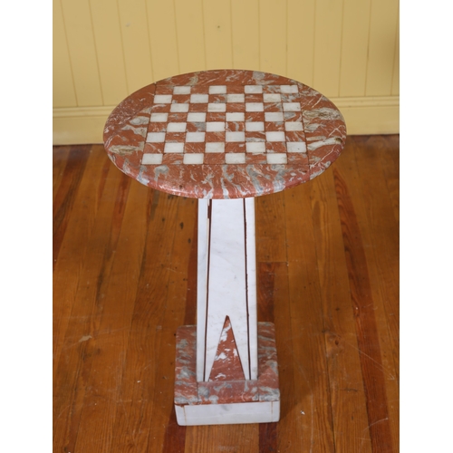 194 - A VEINED MARBLE CHESS TABLE of circular outline the shaped top above a spreading column on platform ... 