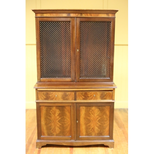 206 - A GEORGIAN STYLE MAHOGANY BOOKCASE the dentil moulded cornice above a pair of brass grill doors cont... 