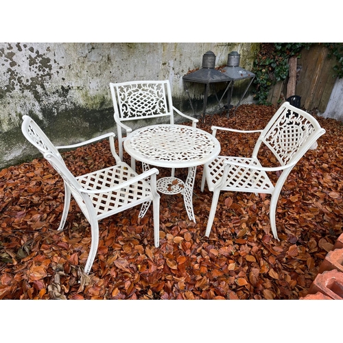 228 - A FOUR PIECE ALUMINIUM PATIO SUITE comprising three elbow chairs the lattice work and foliate splat ... 