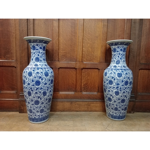 264 - A PAIR OF BLUE AND WHITE VASES each of bulbous form with flared rim the white ground with stylised f... 