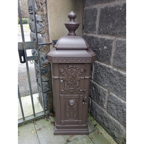 266 - AN ALUMINIUM FREESTANDING POSTBOX of rectangular outline with urn finial and hinged door on platform... 