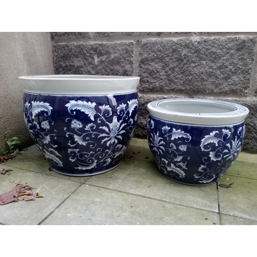 267 - TWO GRADUATED BLUE AND WHITE PLANTERS each of cylindrical tapering form the blue ground decorated ov... 