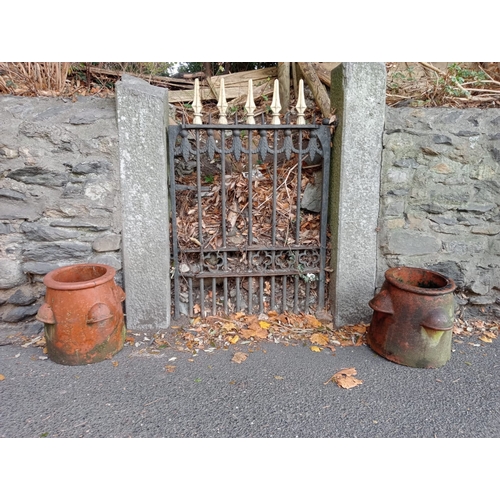 276 - A PAIR OF TERRACOTTA CHIMNEY POTS each of circular spreading form