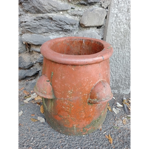 276 - A PAIR OF TERRACOTTA CHIMNEY POTS each of circular spreading form