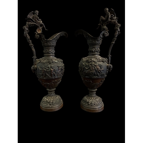 284 - A PAIR OF 19TH CENTURY FRENCH BRONZE EWERS each with fruiting vines scroll handles surmounted by a w... 