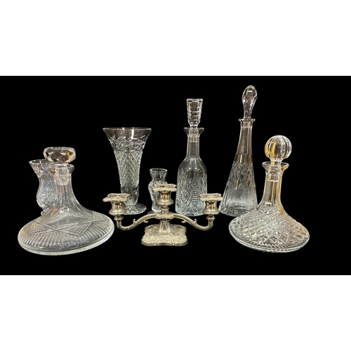 287 - A COLLECTION OF GLASSWARE to include Waterford cut glass decanters, cut glass vases, a plated three ... 