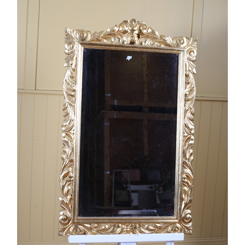 294 - A CONTINENTAL CARVED GILTWOOD MIRROR the rectangular plate within a pierced foliate frame 112cm (h) ... 