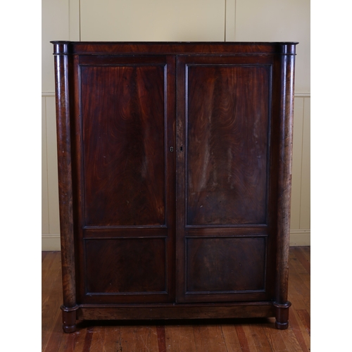 3 - A 19TH CENTURY MAHOGANY WARDROBE the moulded cornice above a pair of panel doors containing hanging ... 