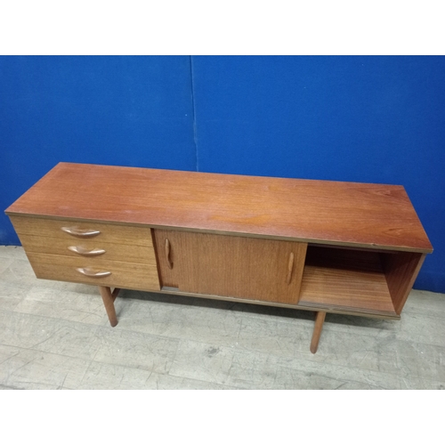 304 - A VINTAGE TEAK SIDEBOARD of rectangular outline the shaped top with sliding door cupboards and three... 