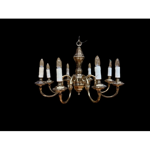 338 - A PAIR OF BRASS EIGHT BRANCH CHANDELIERS the faceted column issuing eight scroll arms with circular ... 