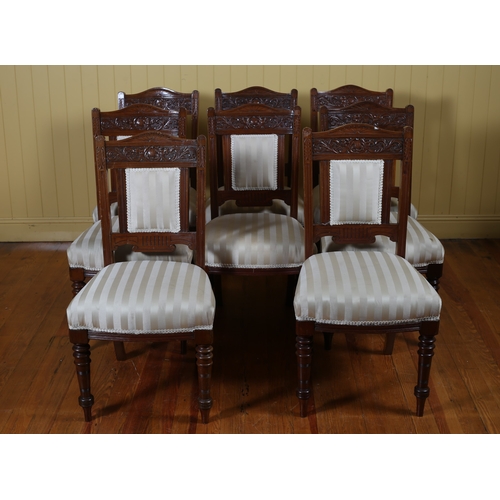 339 - A NINE PIECE EDWARDIAN MAHOGANY DINING ROOM SUITE comprising eight chairs each with a carved top rai... 