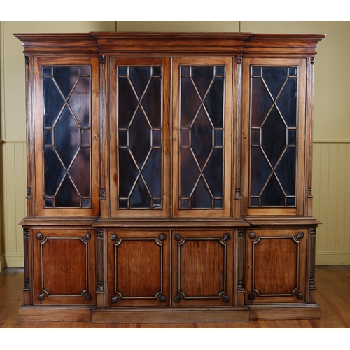 342 - A GEORGIAN STYLE MAHOGANY BREAKFRONT LIBRARY BOOKCASE the moulded cornice above four astragal glazed... 