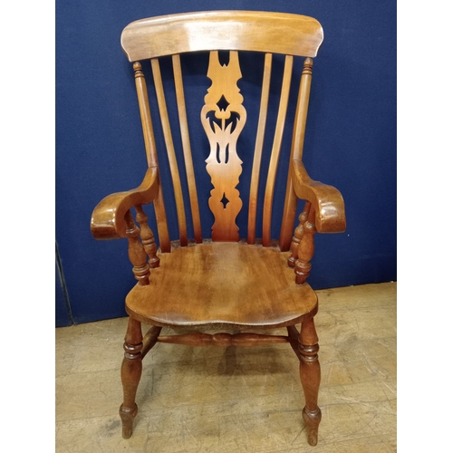 348 - A STAINED HARDWOOD WINDSOR CHAIR the shaped top rail above a pierced vertical splat with shaped seat... 