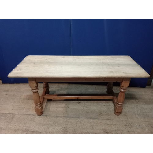 352 - A VINTAGE PINE FARMHOUSE TABLE of rectangular outline with rounded corners on baluster legs joined b... 