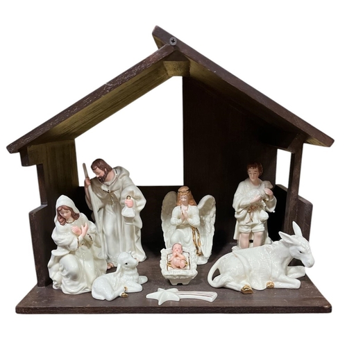 443 - A STAINED BEECHWOOD CRIB containing six Belleek China Figures Nativity Collection 35cm (h) x 40cm (w... 