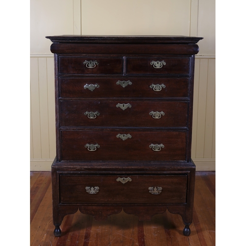 55 - A GEORGIAN OAK CHEST ON CHEST the moulded cornice above two short and three long graduated drawers w... 