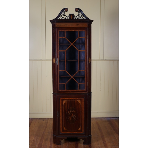 61 - A GEORGIAN MAHOGANY AND SATINWOOD INLAID CORNER CABINET the pierced swan neck pediment above an astr... 