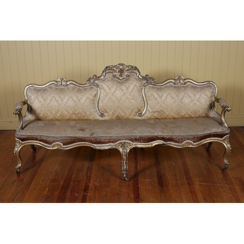 9 - A 19TH CENTURY CARVED GILTWOOD AND UPHOLSTERED SETTEE the serpentine top rail with pierced foliate a... 