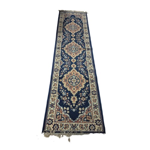 571 - A BLUE, LIGHT PINK AND BEIGE GROUND PATTERN RUNNER, A BLUE GROUND PATTERN RUG with Greek Key border