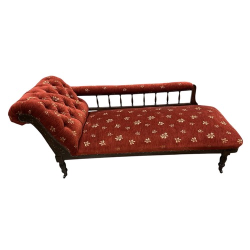 641 - AN EDWARDIAN MAHOGANY SPINDLE BACK CHAISE LOUNGE the wine upholstery decorated with floral design 16... 