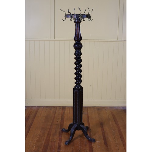 15 - A 19TH CENTURY MAHOGANY COAT STAND the spiral twist fluted and carved column surmounted by a shaped ... 