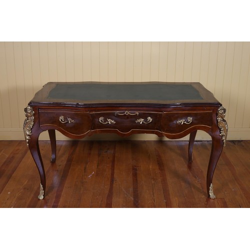 83 - A CONTINENTAL KINGWOOD INLAID AND GILT BRASS MOUNTED WRITING TABLE of serpentine outline the shaped ... 