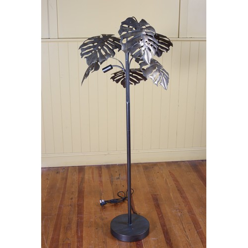 101 - A GILT METAL STANDARD LAMP in the form of a palm tree the cylindrical column on a circular spreading... 