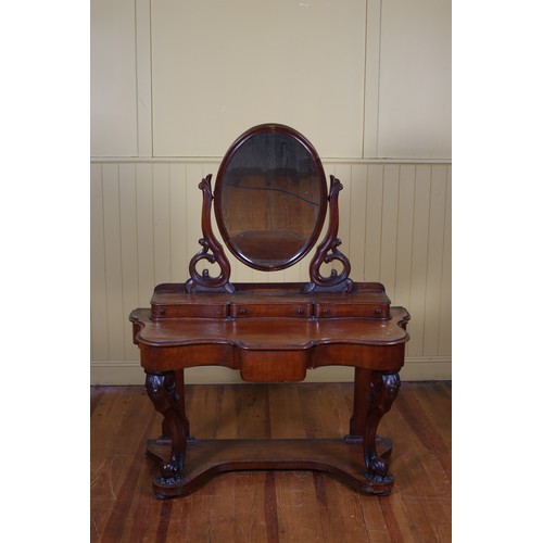 179 - A 19TH CENTURY MAHOGANY DRESSING TABLE the superstructure with oval swivel mirror above three long d... 