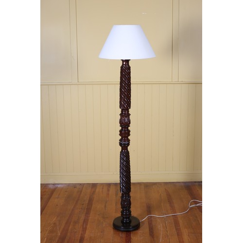 195 - A 19TH CENTURY MAHOGANY STANDARD LAMP the spiral twist ring turned and foliate carved column above a... 