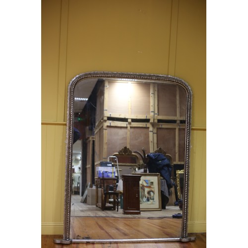 223 - A 19TH CENTURY SILVER FRAME OVERMANTEL MIRROR the rectangular arched plate within a roped and stylis... 