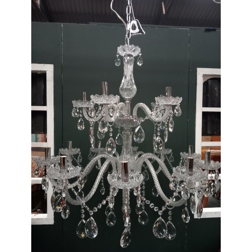 335 - A CONTINENTAL TWELVE BRANCH CUT GLASS CHANDELIER in two registers hung with faceted chains and penda... 