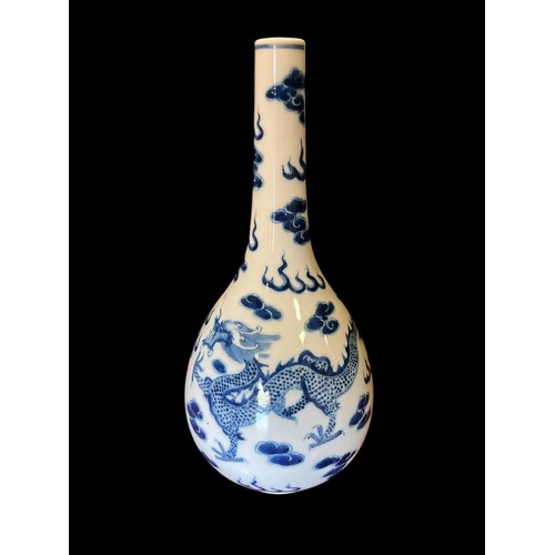 509 - A CHINESE PORCELAIN BLUE AND WHITE VASE the white ground decorated with dragons 32cm (h) x 14cm (d)