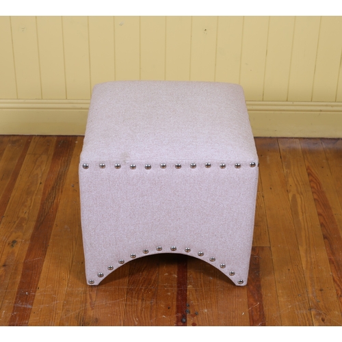 83 - A PINK UPHOLSTERED FOOTSTOOL of rectangular outline with metal studs on shaped support 43cm (h) x 45... 