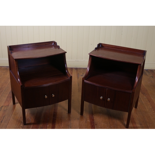 95 - A PAIR OF GEORGIAN STYLE MAHOGANY TWO TIER END TABLES of demi lune outline the shaped top with mould... 