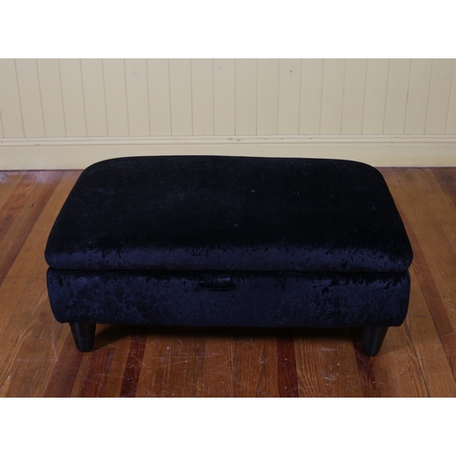 99 - A BLACK VELVET UPHOLSTERED FOOTSTOOL of rectangular outline with hinged seat raised on cylindrical t... 