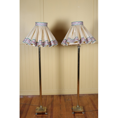 100 - A PAIR OF BRASS STANDARD LAMPS the reeded column's with Corinthian capital on square stepped base wi... 