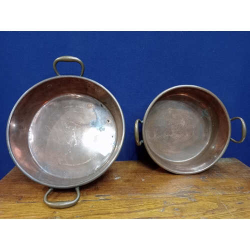 490 - TWO 19TH CENTURY COPPER AND BRASS PRESERVING PANS each of cylindrical form with pierced handles