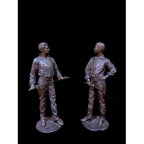 491 - A PAIR OF SPELTER FIGURES each modelled as a fencer shown standing on a naturalistic base 55cm (h), ... 