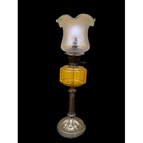 105 - A 19TH CENTURY BRASS OIL LAMP the etched glass shade above a topaz glazed reservoir on a circular sp... 