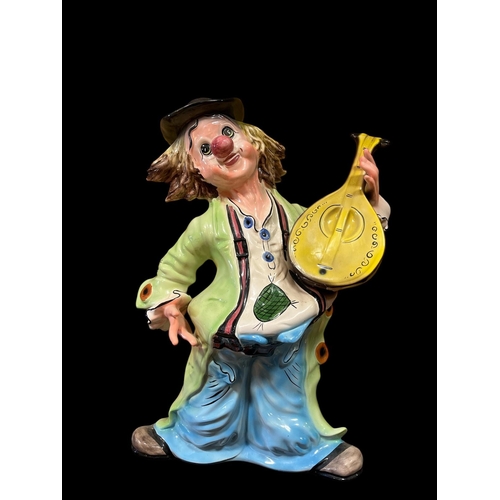 125 - A GLAZED CHINA FIGURE modelled as a clown 79cm (h) x 60cm (w)