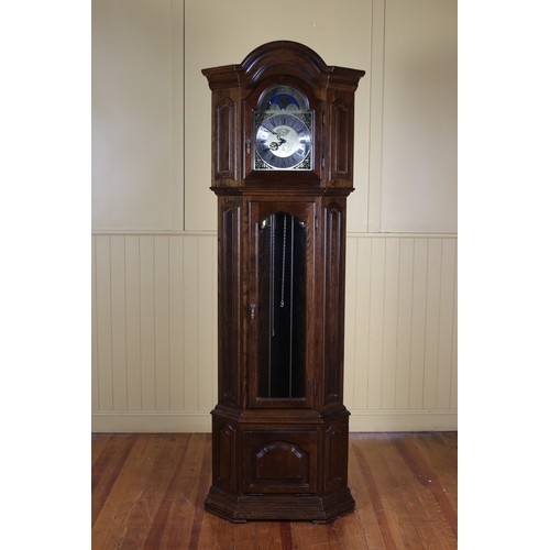 182 - AN OAK LONG CASED CLOCK the arched hood containing a silvered and gilt dial with phases of the moon ... 