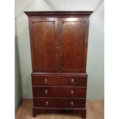 205 - A 19TH CENTURY MAHOGANY LINEN PRESS ON CHEST the dentil moulded cornice above a pair of cupboards co... 