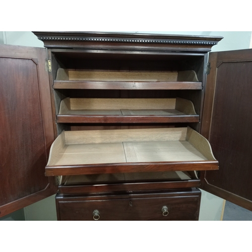 205 - A 19TH CENTURY MAHOGANY LINEN PRESS ON CHEST the dentil moulded cornice above a pair of cupboards co... 