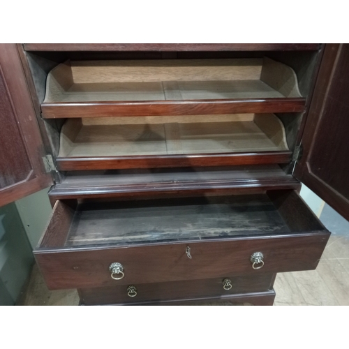 205 - A 19TH CENTURY MAHOGANY LINEN PRESS ON CHEST the dentil moulded cornice above a pair of cupboards co... 