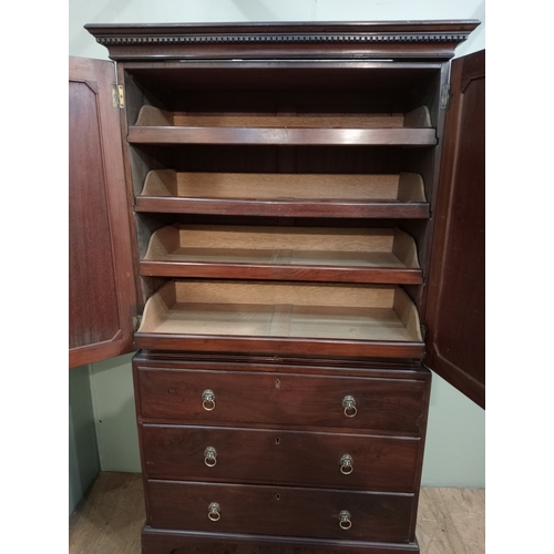 205 - A 19TH CENTURY MAHOGANY LINEN PRESS ON CHEST the dentil moulded cornice above a pair of cupboards co... 