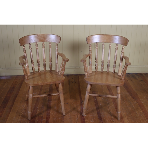 223 - A PAIR OF BEECH FRAME CARVERS each with a curved top rail and baluster splat with panel seat on conf... 